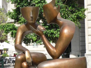 Bronze statue of two people talking