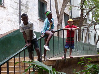 Three children on steps in Cuba